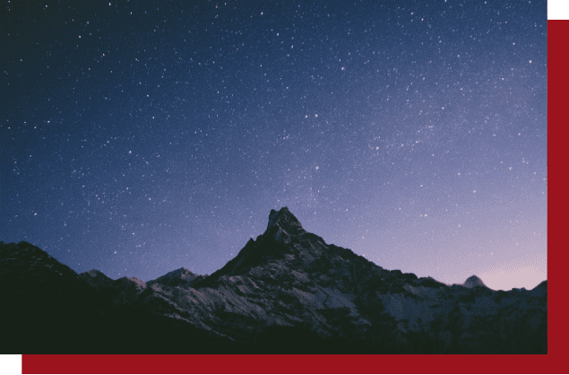 A mountain with stars in the sky and a red band